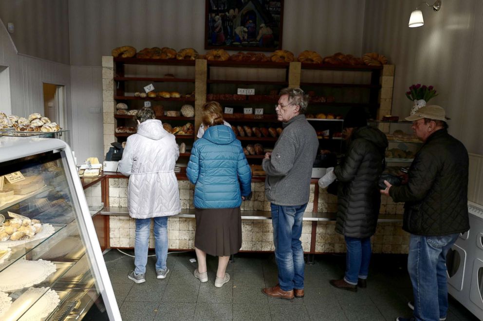 PHOTO: People stand in line at Byfyj bakery in Nikiszowiec district in Katowice, Poland, Oct. 24, 2018.