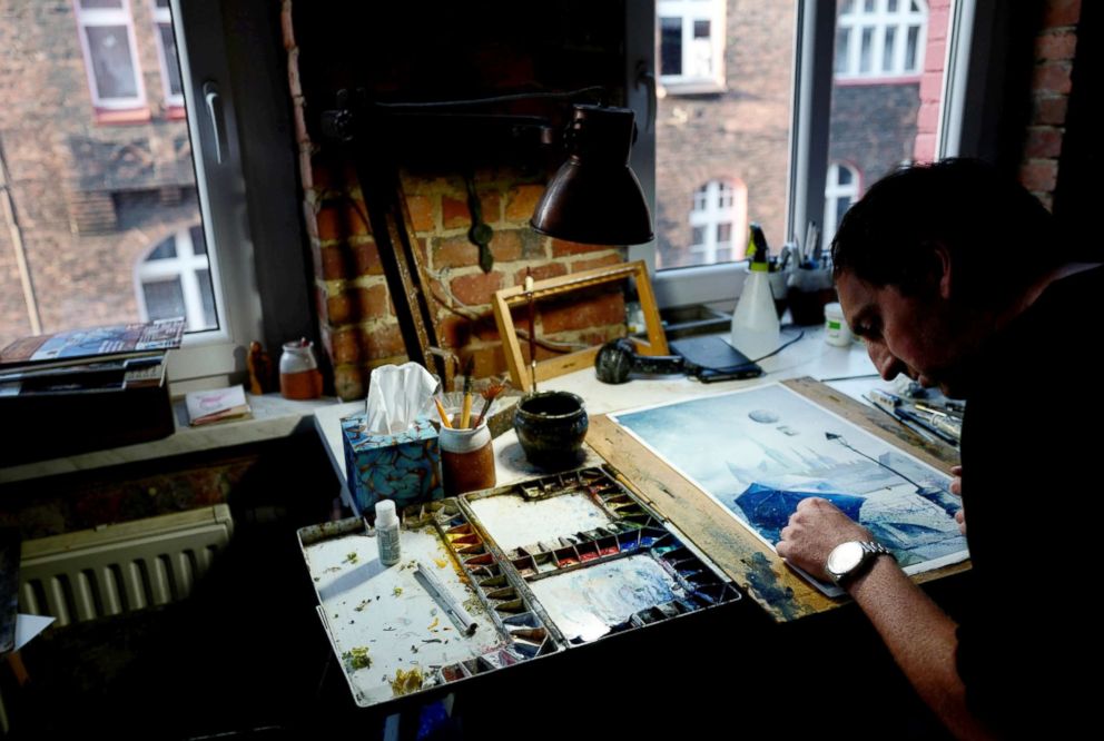 PHOTO: Artist Grzegorz Chudy, 36, paints at his atelier in Nikiszowiec district in Katowice, Poland, Nov. 7, 2018.