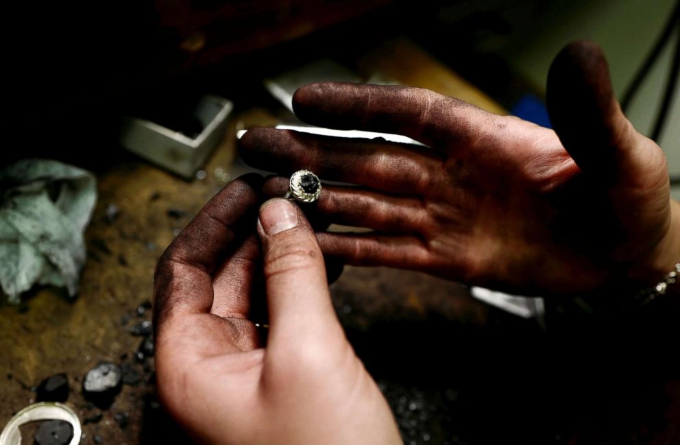 PHOTO: Jeweller Katarzyna Depa, 26, who makes jewellery from coal, holds a silver ring with coal at her atelier in Katowice, Poland, Nov. 26, 2018.