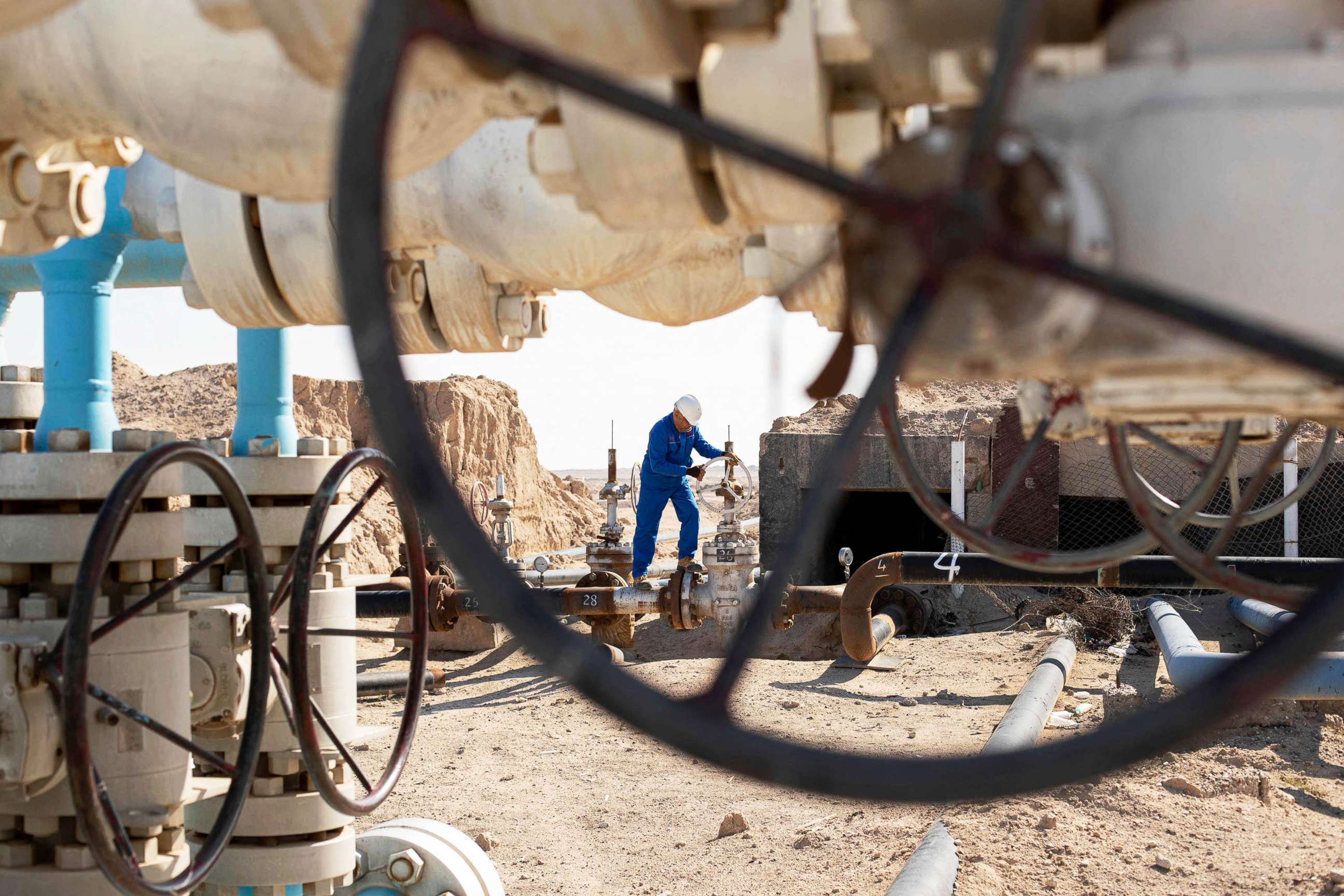PHOTO: A technician works on a processing facility in Artawi, near Iraq's southern port city of Basra on Jan. 19, 2022.