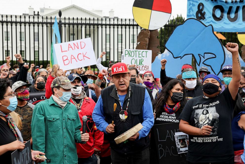 PHOTO: Indigenous people and other climate activists raise their fists during a climate change protest on Indigenous Peoples' Day outside the White House in Washington, Oct. 11, 2021.