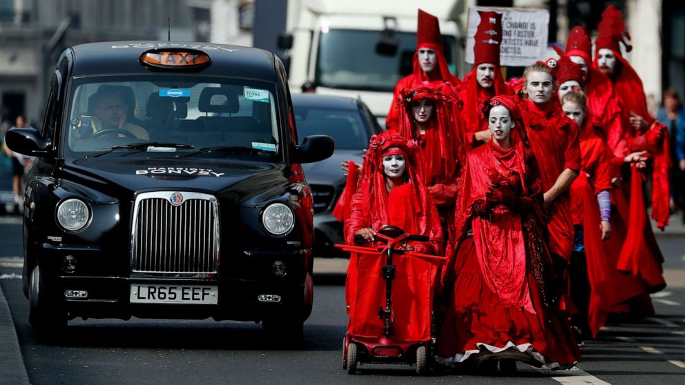 PHOTO: Members of the 'Red Brigade' march in disobedience on the street from Oxford Circus to Piccadilly Circus in London, April 17, 2019.