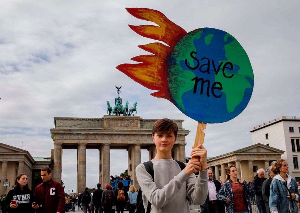 PHOTO: A protester holds a globe-shaped sign reading "Save Me" during the "Fridays for Future" demonstration in Berlin during a protest for climate action on September 20, 2019, part of a global climate action day.