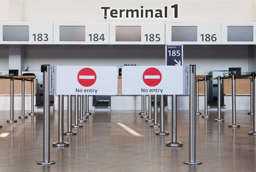 PHOTO:Closed check-in desks are seen in the departure hall of Terminal 1 at Vienna Airport in Schwechat, Austria, March 23, 2020. 