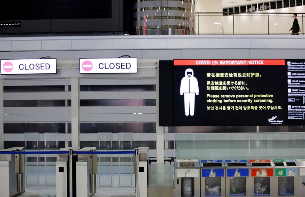 PHOTO: A notice about COVID-19 safety measures is pictured next to closed doors at a departure hall of the international airport in Narita, Japan, on Nov. 30, 2021, on the first day of closed borders to prevent the spread of the omicron variant.