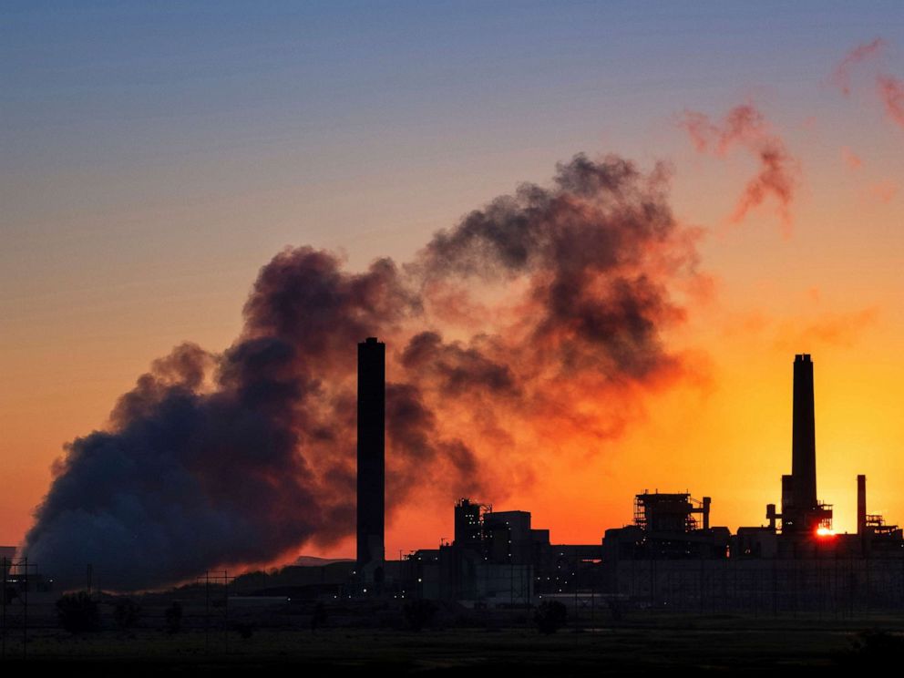PHOTO: In this July 27, 2018 , file photo, the Dave Johnson coal-fired power plant is silhouetted against the morning sun in Glenrock, Wyo.