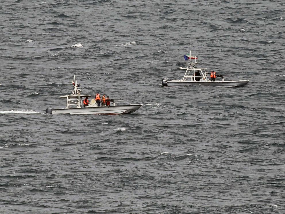 PHOTO: In this March 21, 2017 photograph, members of Iran's paramilitary Revolutionary Guard watch the USS George H.W. Bush as it travels through the Strait of Hormuz.