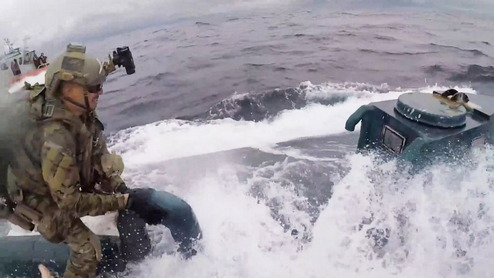 PHOTO: An image made from video released by the U.S. Coast Guard shows a service member of the U.S. Coast Guard cutter Munro boarding a suspected drug smuggling vessel in international waters on the Pacific Ocean on June 18, 2019.