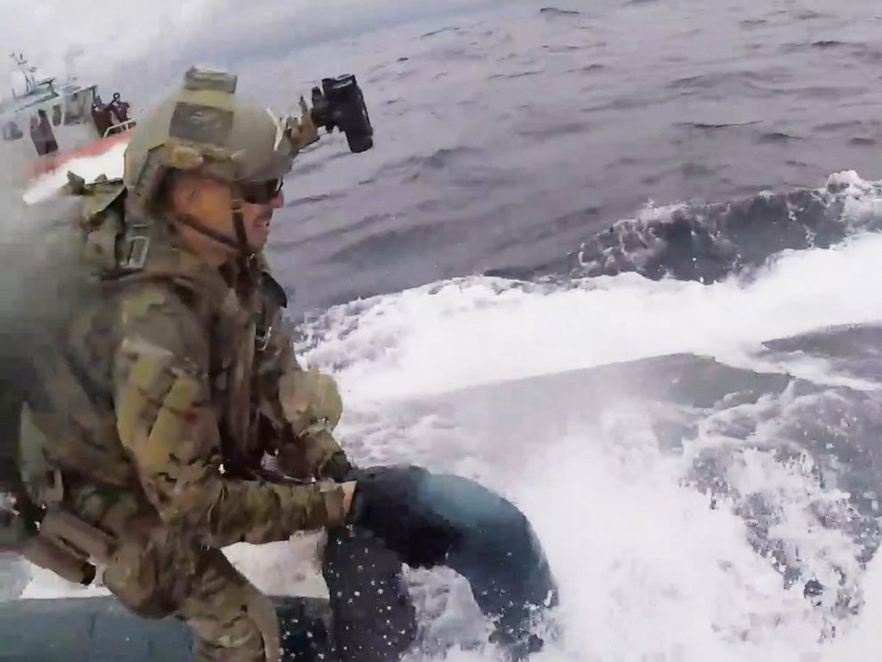 PHOTO: An image made from video released by the U.S. Coast Guard shows a service member of the U.S. Coast Guard cutter Munro boarding a suspected drug smuggling vessel in international waters on the Pacific Ocean on June 18, 2019.