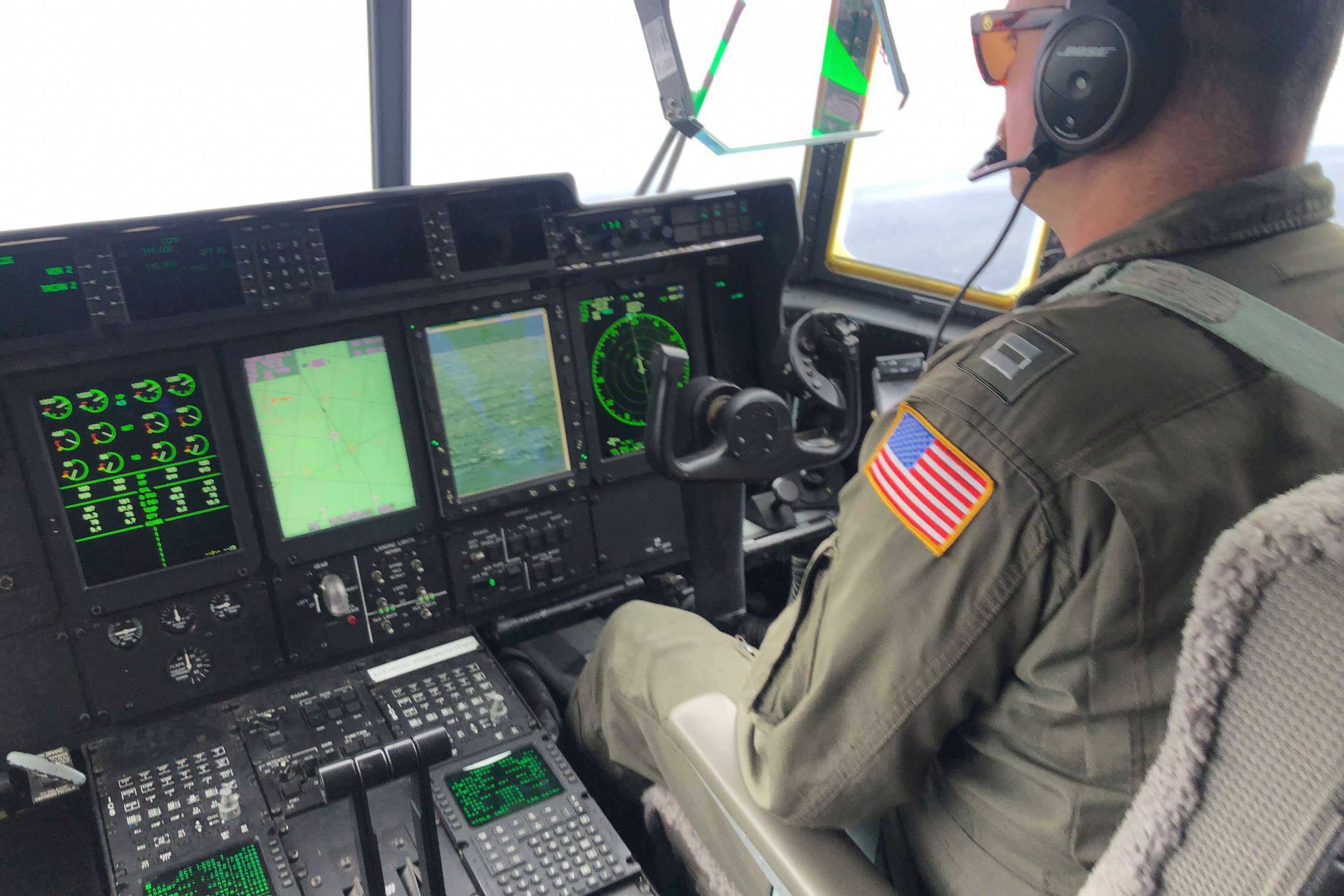 PHOTO: A crew member sits aboard a Coast Guard HC-130 Hercules airplane as it flies about 900 miles East of Cape Cod, Mass., during the search for the submersible Titan, June 21, 2023.
