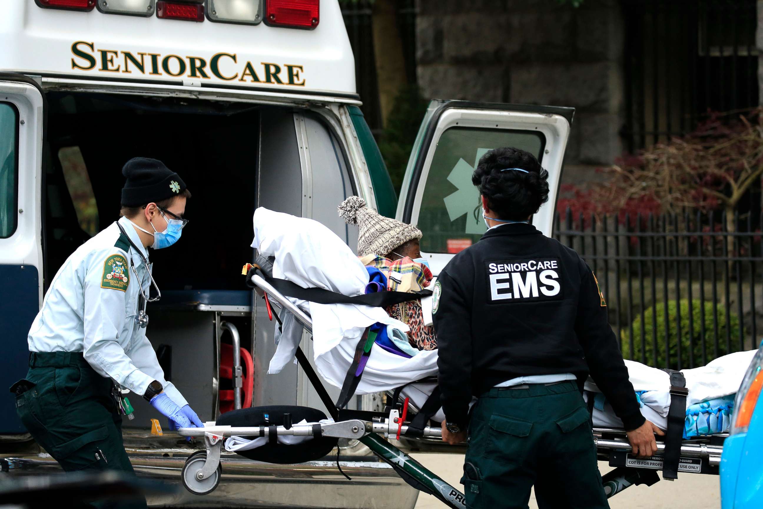 PHOTO: Emergency Medical Service workers unload a patient out of their ambulance at the Cobble Hill Health Center on April 18, 2020 in the Cobble Hill neighborhood of Brooklyn, New York.