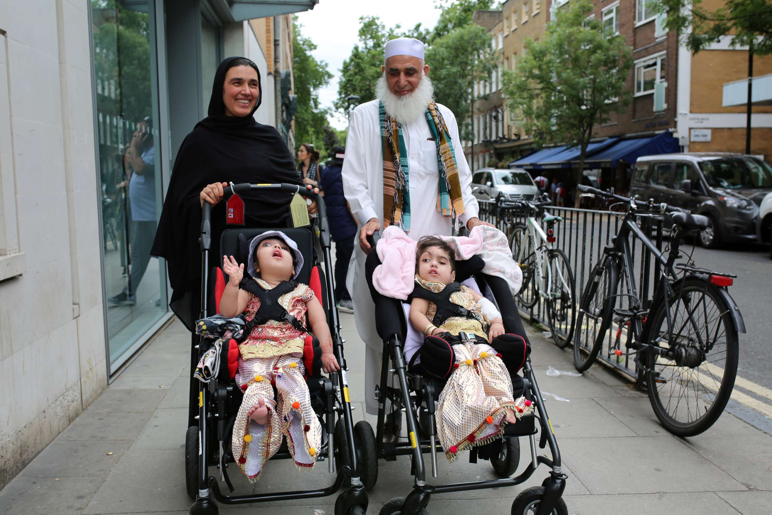 PHOTO: Two-year-old twins, born joined at the head, leave the hospital after a successful surgery at a British hospital in London, on July 1, 2019, in this handout photo released on July 16, 2019. 