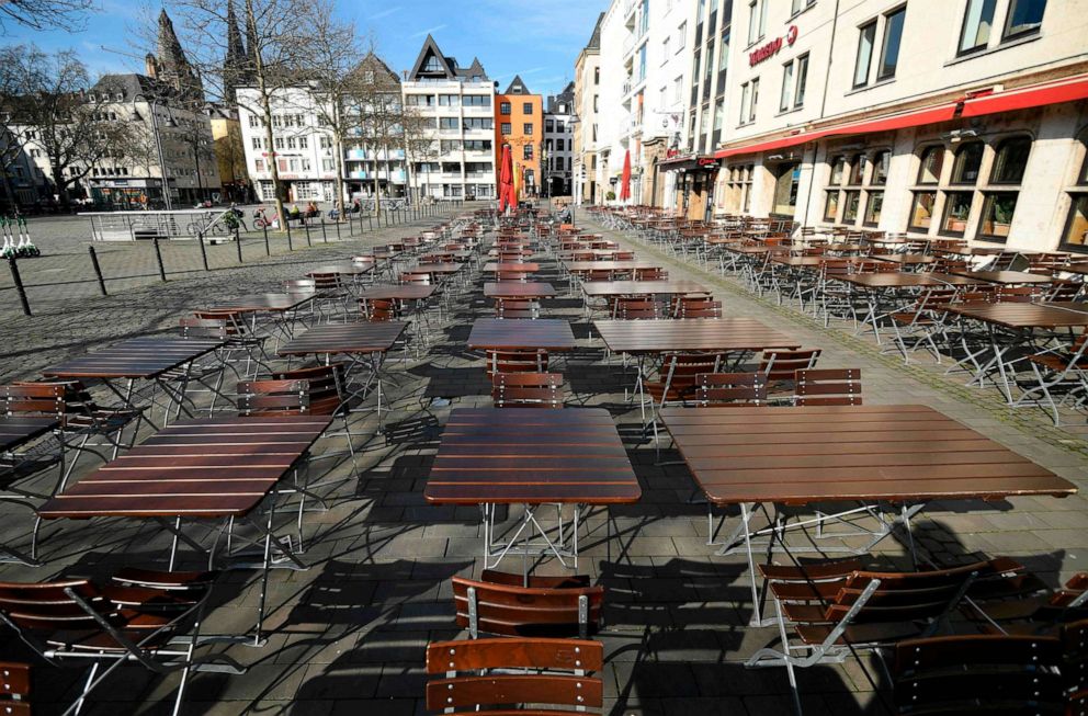 PHOTO: Empty tables and chairs of a street cafe are seen, March 17, 2020 in Cologne, western Germany, where restaurants closed, as well as many activities slowed down or came to a halt due to the spread of the novel coronavirus.