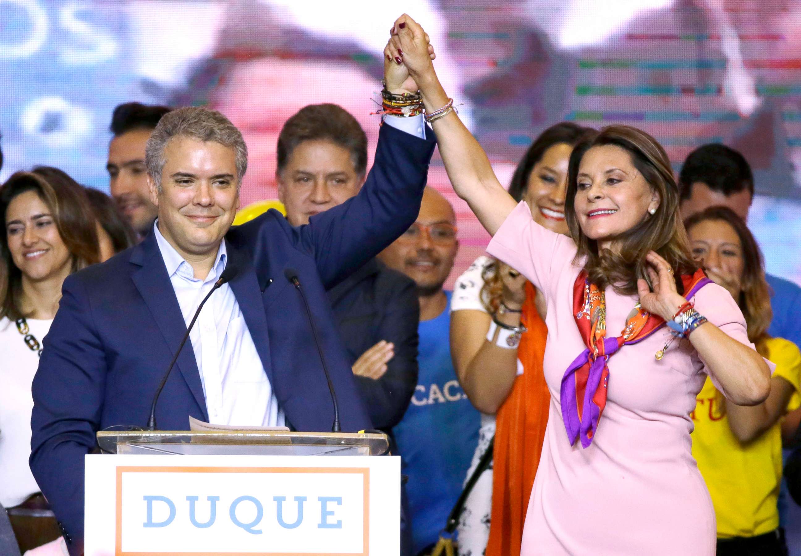 PHOTO: Ivan Duque, presidential candidate for the Democratic Center, left, and his vice presidential formula Marta Lucia Ramirez raise arms after winning the first round presidential election in Bogota, Colombia, May 27, 2018.