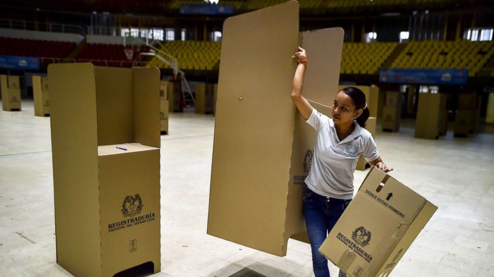 A worker assembles voting booths at a polling station in Cali, Colombia, May 25, 2018.