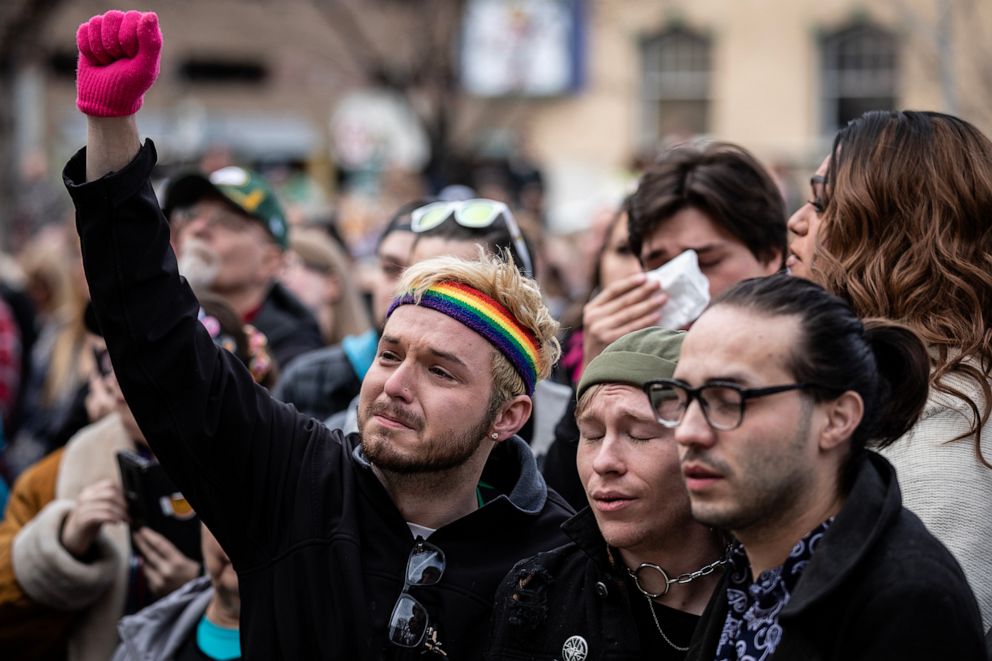 PHOTO: Mourners attend a ceremony where a rainbow flag was draped over the City Hall building in honor of the victims of a shooting at Club Q in Colorado Springs, Colo., Nov. 23, 2022.