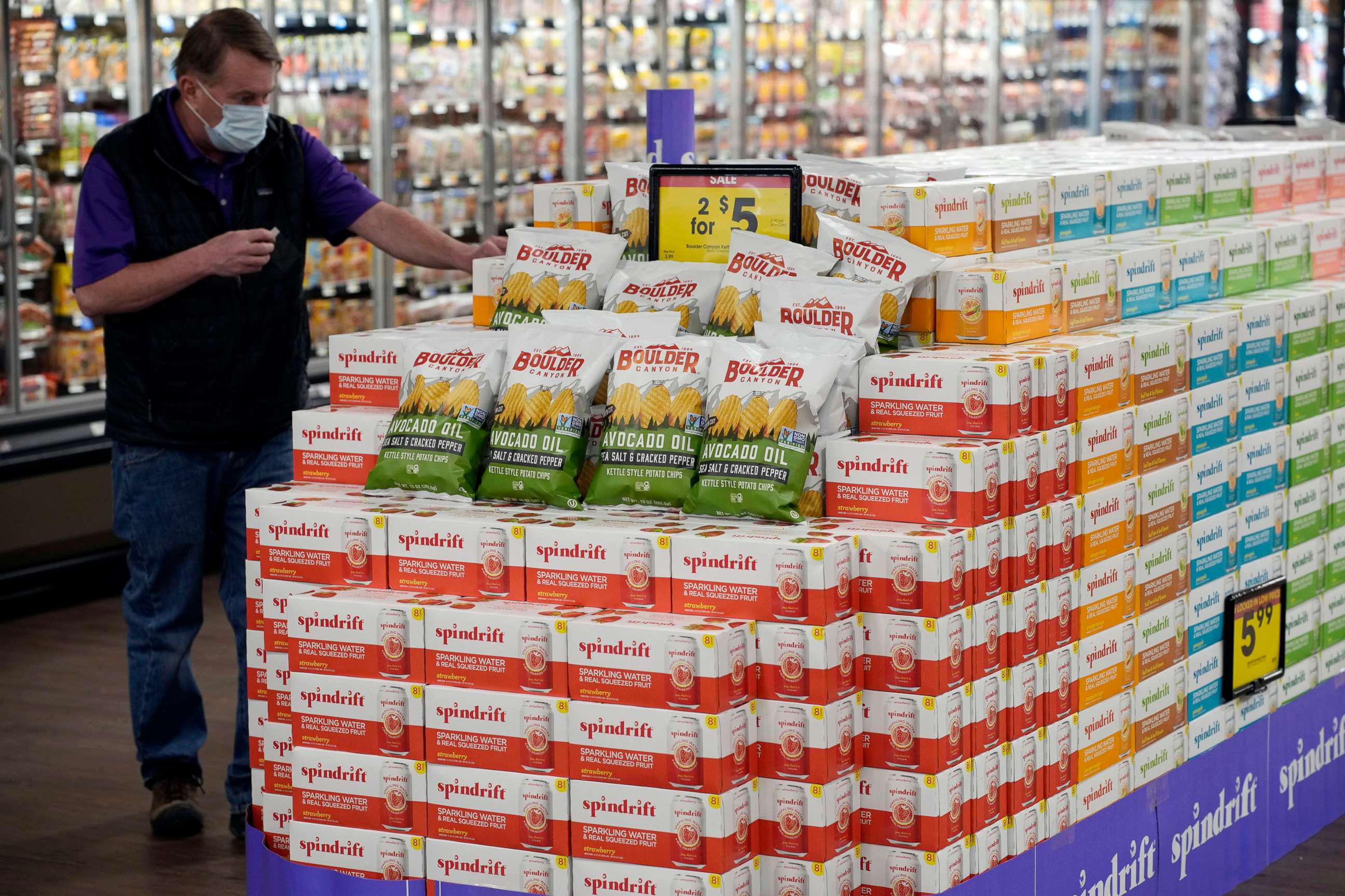 PHOTO: A worker stocks a display of chips and soda in the Table Mesa King Soopers during a media tour in Boulder, Colo., Feb. 8, 2022. 