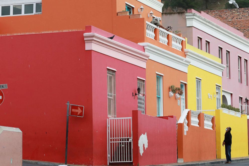 PHOTO: A man, wearing a face mask to protect against the novel coronavirus, speaks to a woman in a building in Bo-Kaap neighborhood of Cape Town, South Africa, on May 23, 2020.