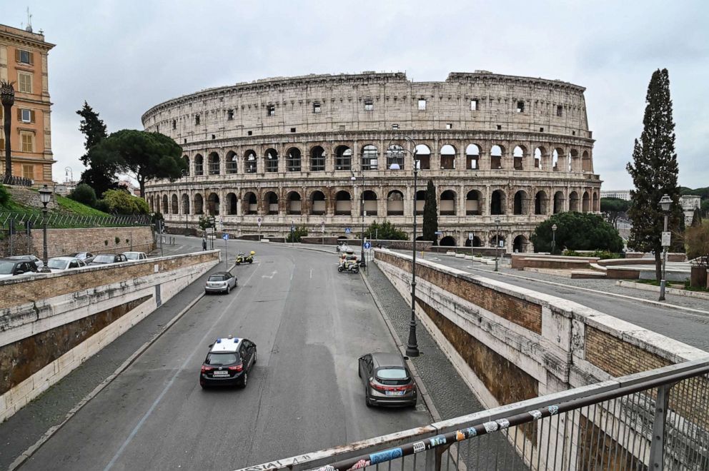 PHOTO: An Italian Carabinieri car checks the traffic of the street around ancient Colosseum, in Rome, March 14, 2020, during the COVID-19 outbreak.