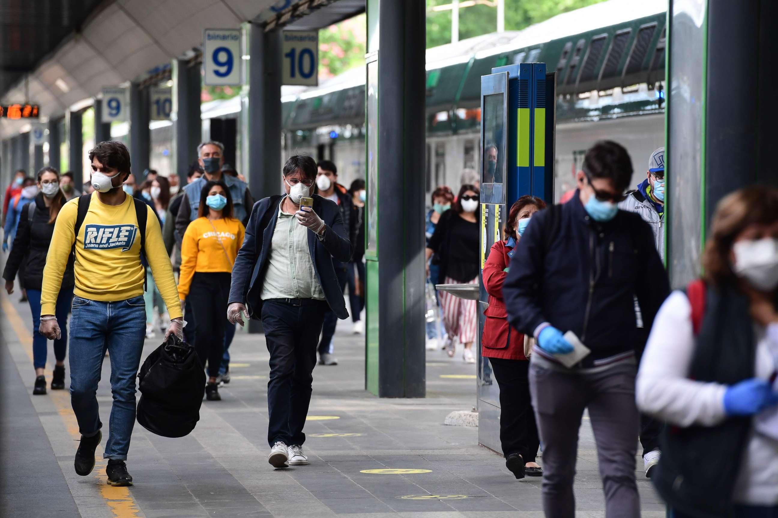 PHOTO: Commuters arrive from a regional train at the Cardona railway station in Milan on May 4, 2020, as Italy starts to ease its lockdown aimed at curbing the spread of the novel coronavirus.