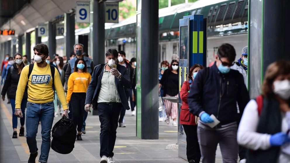 PHOTO: Commuters arrive from a regional train at the Cardona railway station in Milan on May 4, 2020, as Italy starts to ease its lockdown aimed at curbing the spread of the novel coronavirus.