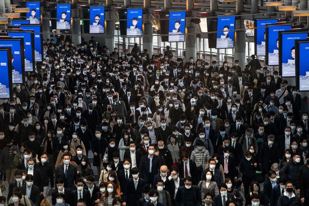 PHOTO: Commuters, mostly wearing face masks, walk through Shinagawa train station in Tokyo, Japan, on Nov. 18, 2020 in Tokyo, Japan.