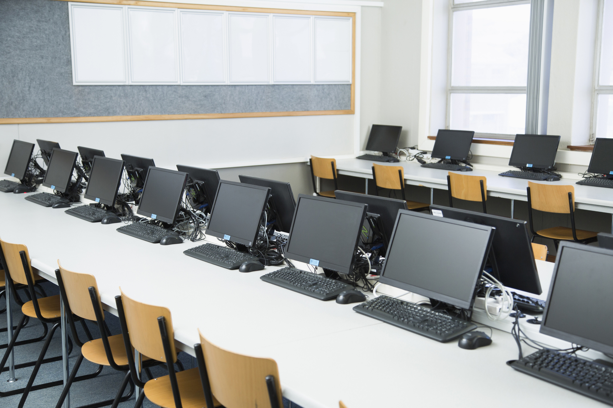 PHOTO: Empty classroom with rows of personal computers on desk pictured in this undated stock photo.