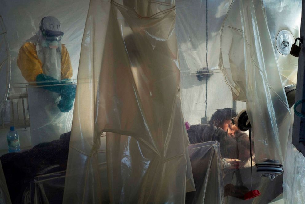 PHOTO: A health worker wearing protective equipment checking an isolated patient in a plastic cube at an Ebola treatment center in Beni, Congo, on July 13, 2019.