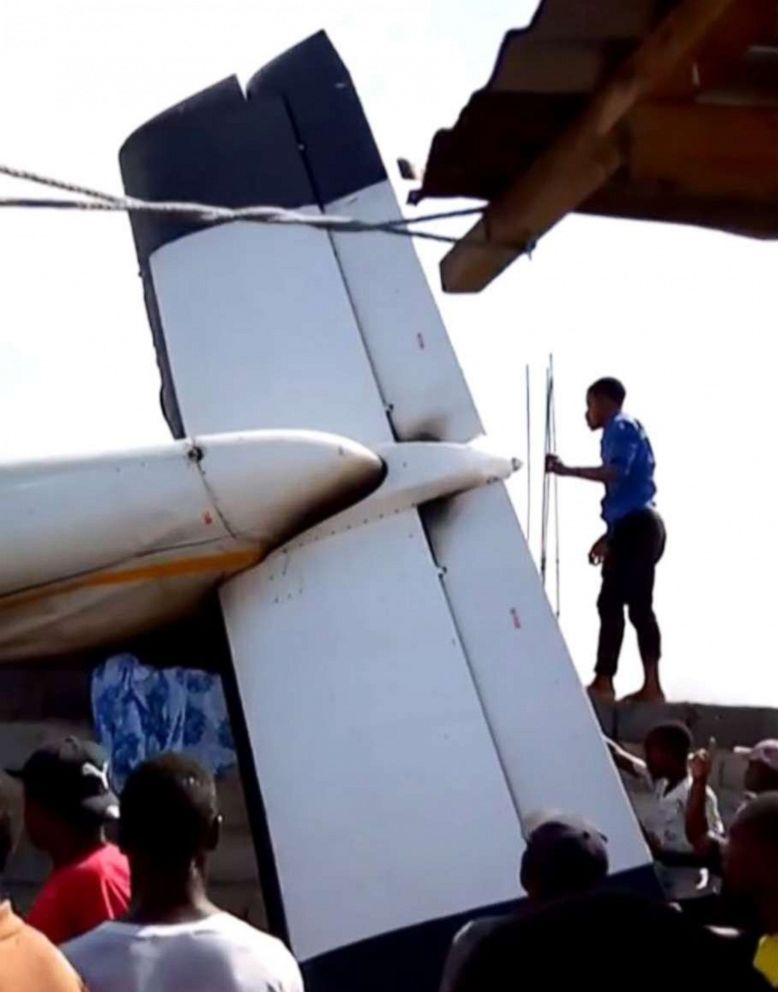PHOTO: This image grab taken from a video shows people gathering near the wreckage of a plane after it crashed on takeoff into a densely populated area of Goma in the Democratic Republic of Congo, Nov. 24, 2019. 