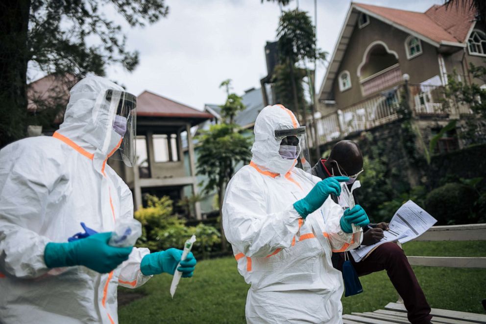 PHOTO: Staff members of the Congolese Ministry of Health perform a COVID-19 test at a private residence in Goma, northeastern Democratic Republic of Congo, on March 31, 2020.