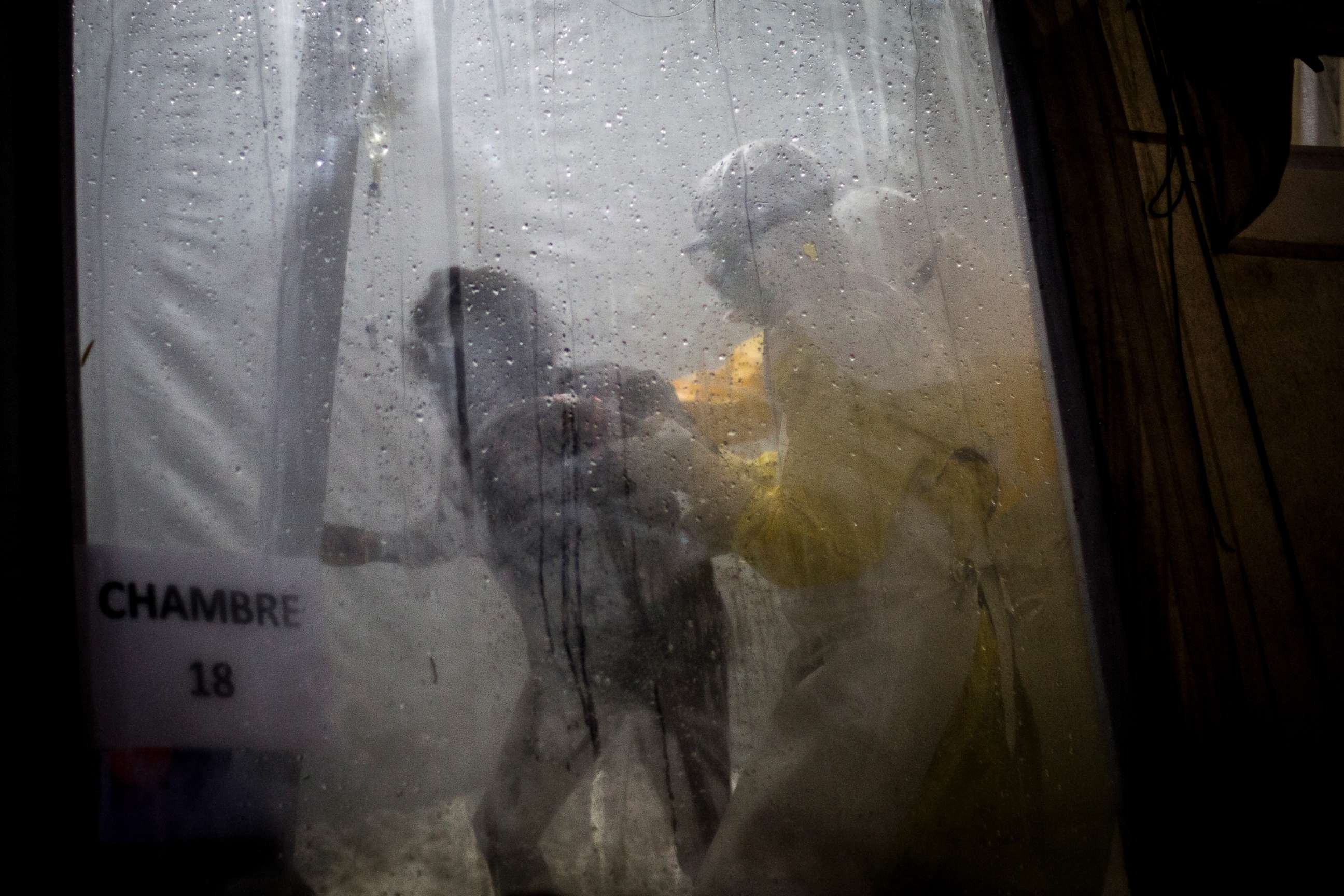 PHOTO: Health workers are seen helping an unconfirmed Ebola patient into her bed inside of a Medecins Sans Frontieres supported Ebola treatment center in Butembo, Congo, Nov. 3, 2018.