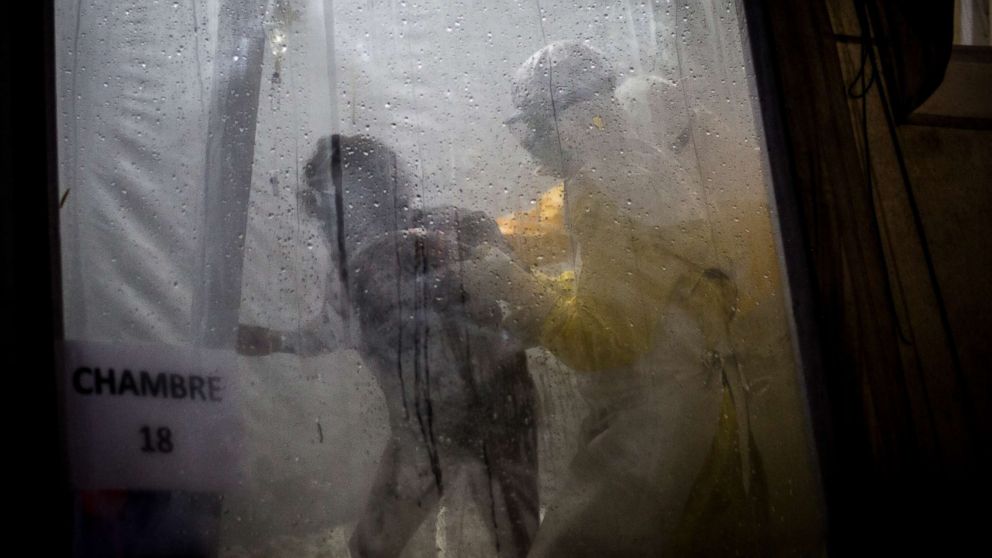 PHOTO: Health workers are seen helping an unconfirmed Ebola patient into her bed inside of a Medecins Sans Frontieres supported Ebola treatment center in Butembo, Congo, Nov. 3, 2018.