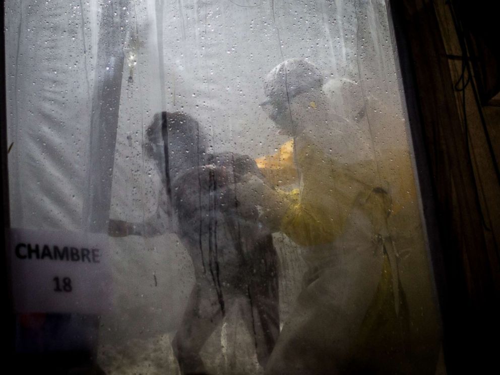 PHOTO: Health workers are seen helping an unconfirmed Ebola patient into her bed inside of a Medecins Sans Frontieres supported Ebola treatment center in Butembo, Congo, Nov. 3, 2018.