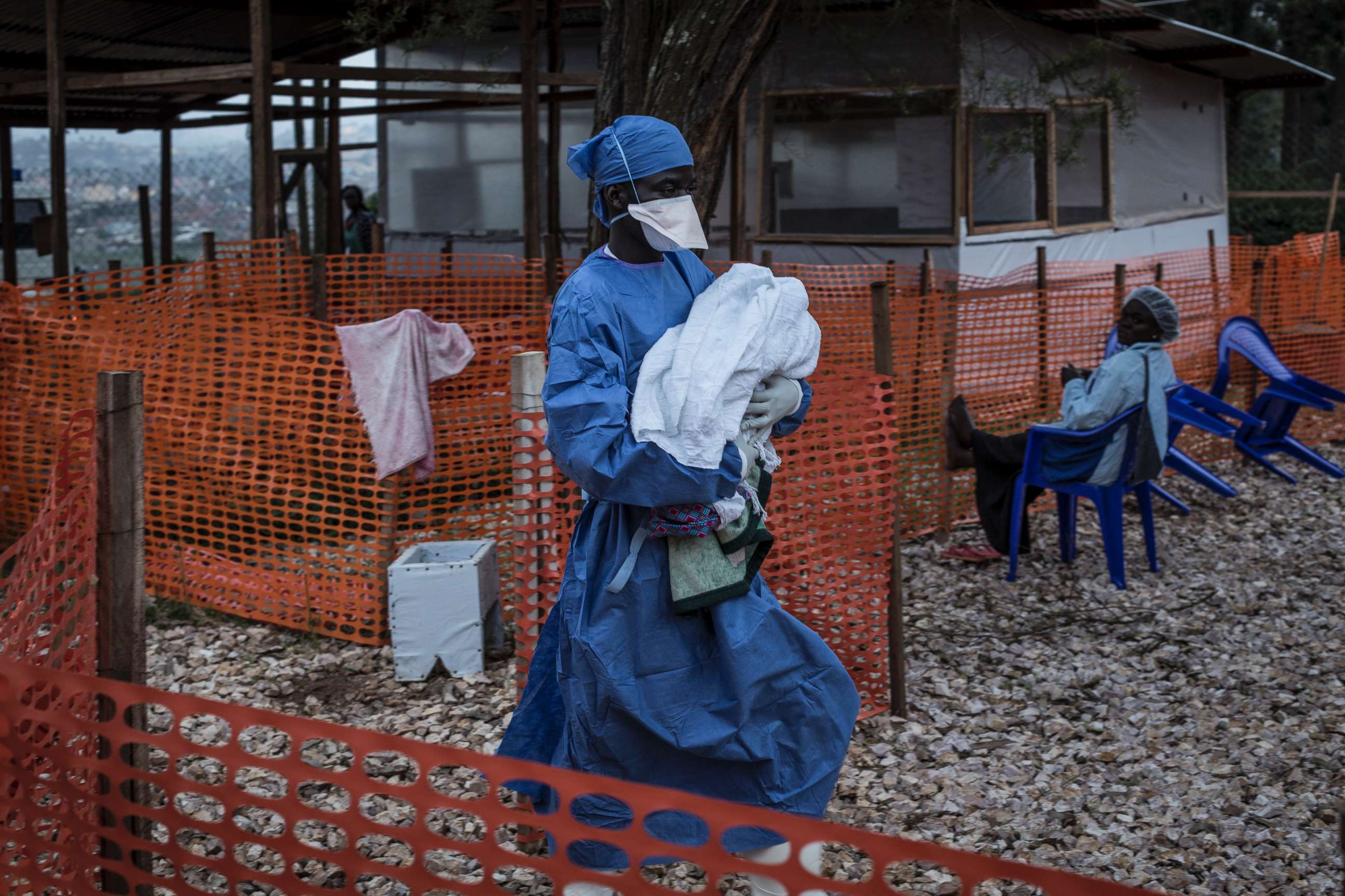 PHOTO: A caretaker already cured of Ebola is seen carrying a four day old baby suspected of having Ebola into a Medecins Sans Frontieres supported Ebola treatment center in Butembo, Congo in this Nov. 4, 2018 file photo.