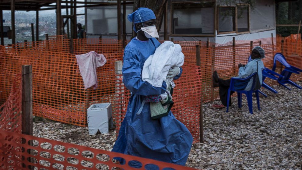 PHOTO: A caretaker already cured of Ebola is seen carrying a four day old baby suspected of having Ebola into a Medecins Sans Frontieres supported Ebola treatment center in Butembo, Congo, Nov. 4, 2018.