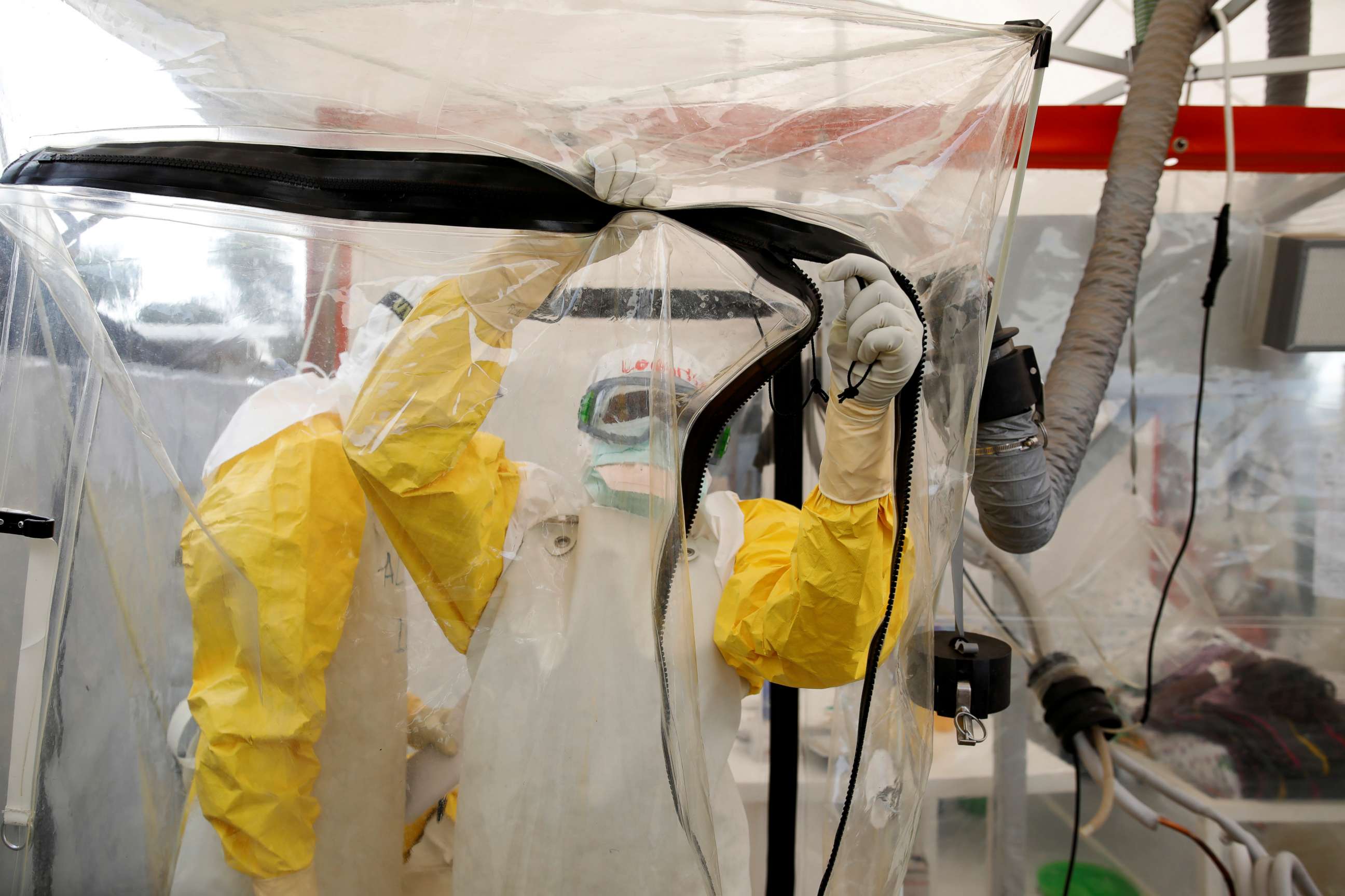 PHOTO: A health worker wearing Ebola protection gear enters the Biosecure Emergency Care Unit (CUBE) at the ALIMA (The Alliance for International Medical Action) Ebola treatment center in Beni, in the Democratic Republic of the Congo, April 1, 2019.