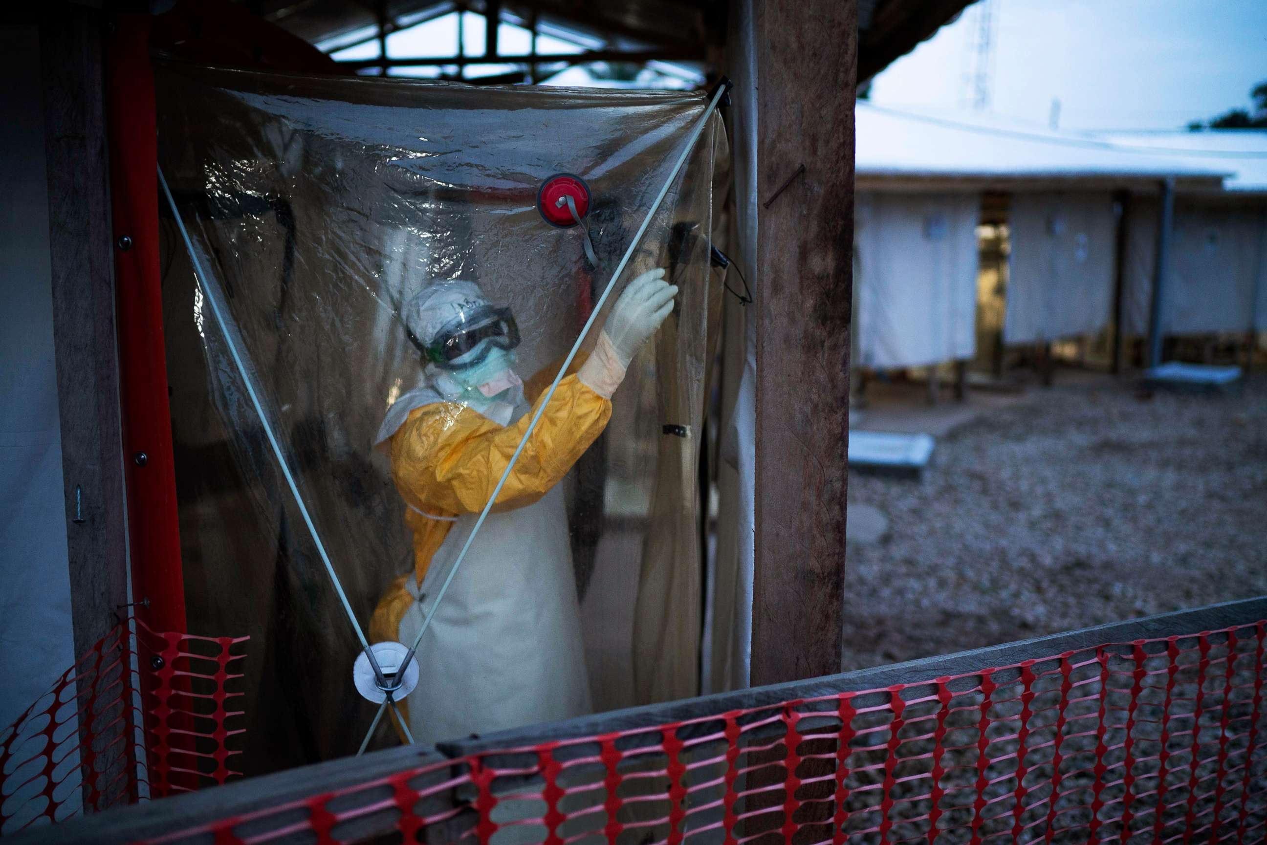 PHOTO: A health worker wearing a protective suit enters an isolation pod to treat a patient at a treatment center in Beni, Democratic Republic of Congo, July 13, 2019.