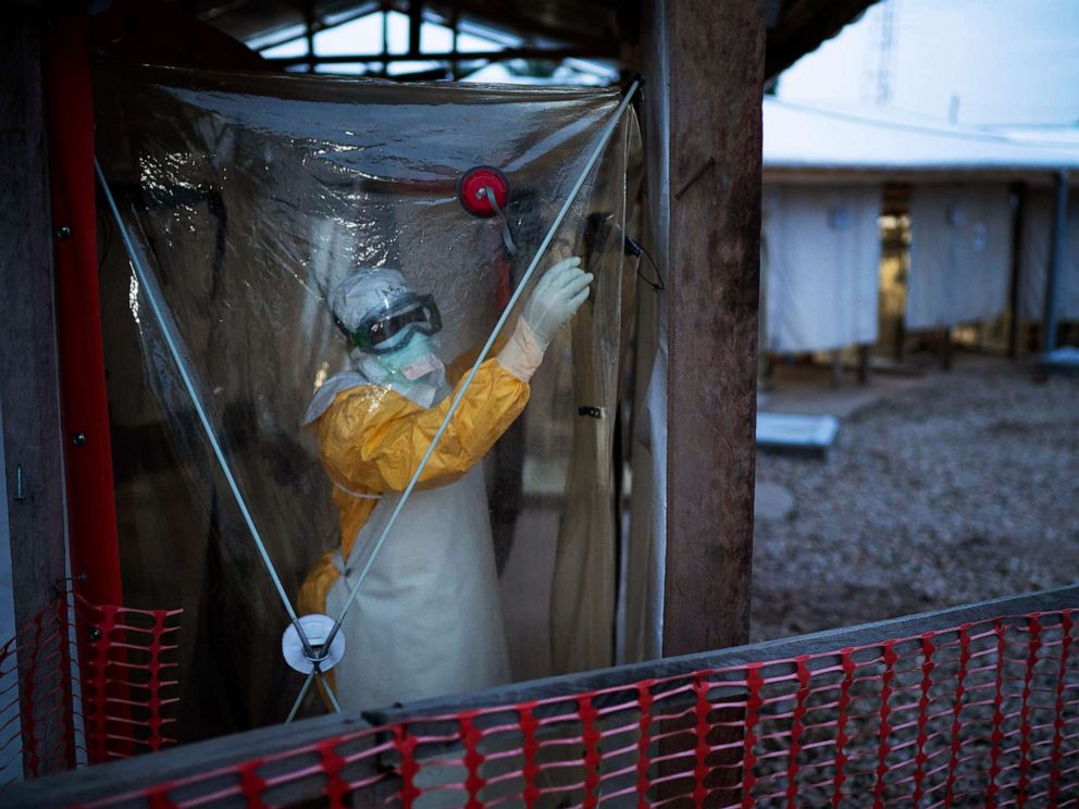 PHOTO: A health worker wearing a protective suit enters an isolation pod to treat a patient at a treatment center in Beni, Democratic Republic of Congo, July 13, 2019.