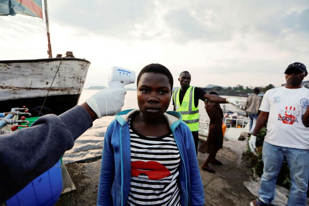 PHOTO: Health workers checks the temperature of citizens as part of the Ebola screening procedure upon their arrival to the North of Lake Kivu in Kituku, in the eastern Democratic Republic of Congo, Sept. 29, 2019.