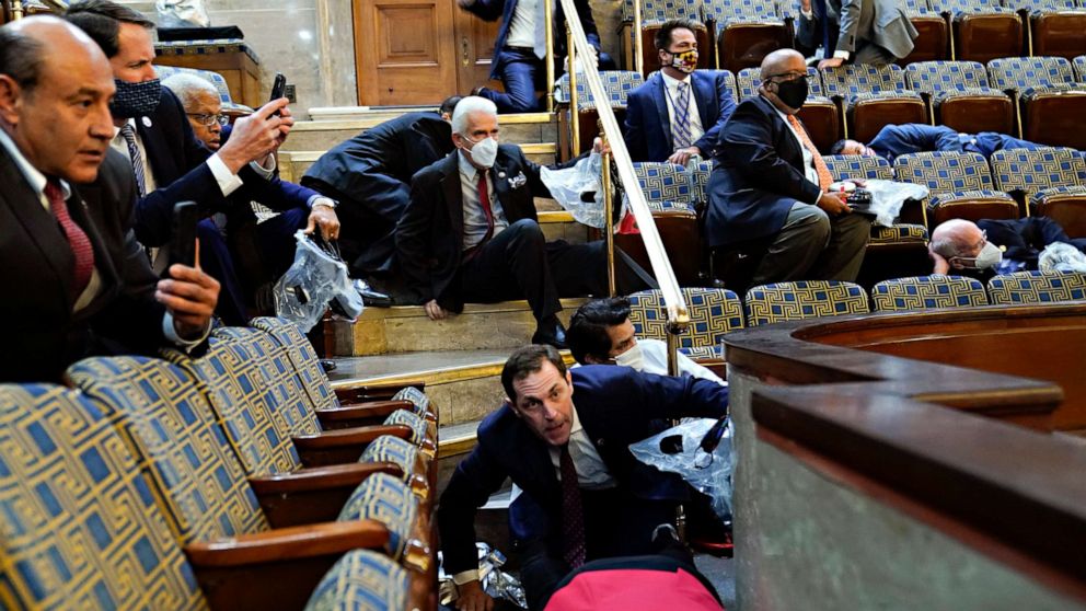 PHOTO: People shelter in the House gallery as protesters try to break into the House Chamber at the U.S. Capitol on Jan. 6, 2021, in Washington.