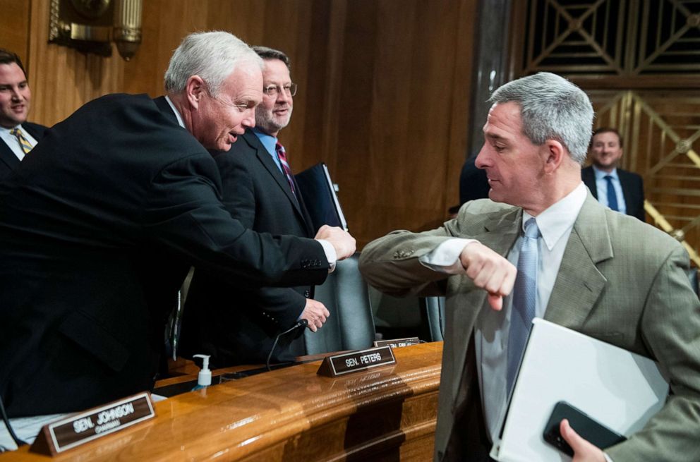 PHOTO: Ken Cuccinelli, right, acting deputy secretary for the Department of Homeland Security, elbow bumps Chairman Ron Johnson to avoid shaking hands due to the coronavirus outbreak, during a hearing, March 5, 2020, in Washington, D.C.