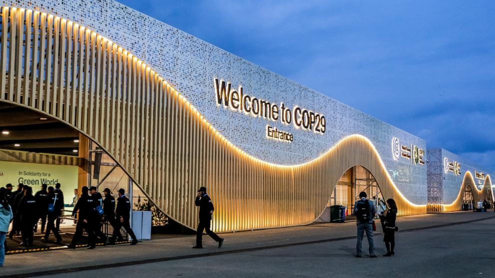 PHOTO: Participants walk by the entrance of COP29, the UN Climate Change Conference venue, an event held by UNFCCC at Baku Olympic Stadium on Nov. 11, 2024.