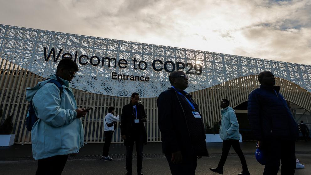 PHOTO: Participants gather at the entrance to the United Nations Climate Change Conference (COP29), in Baku, Azerbaijan November 14, 2024.