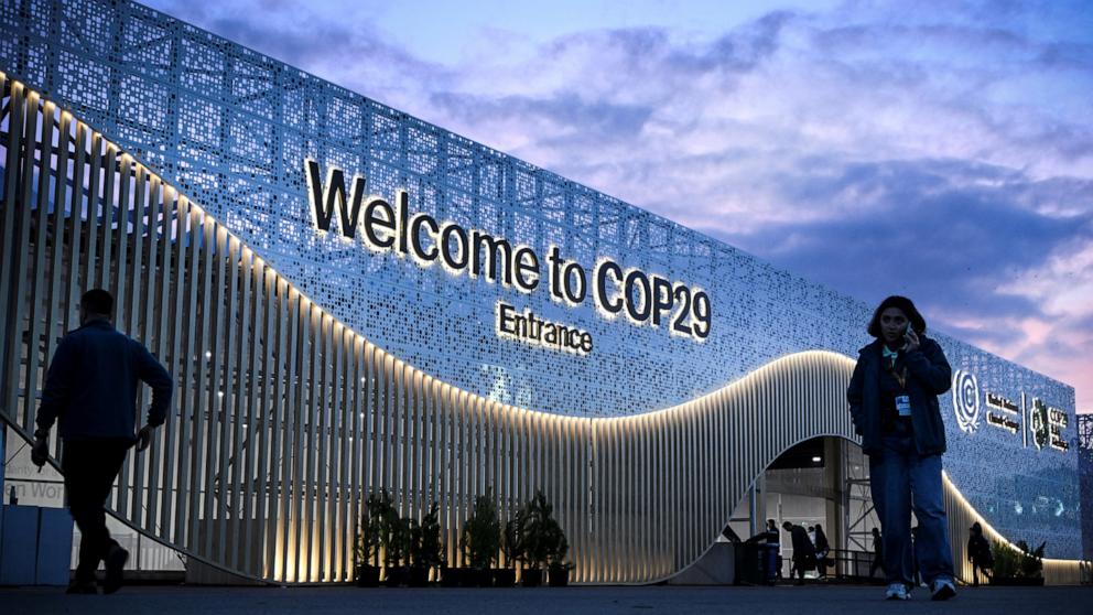 PHOTO: Pedestrian walk in front of the venue for COP 29 Summit in Baku on Nov. 10, 2024, on the eve of UN Climate Change Conference. 