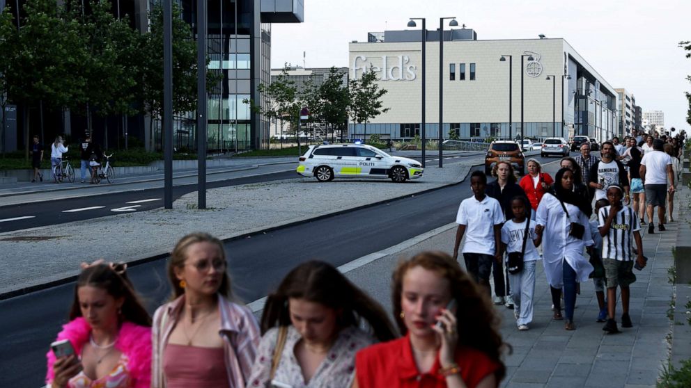 PHOTO: People gather in front of the Fields shopping center during evacuation by armed police in Oerstad, Copenhagen, Denmark, July 3 2022. 