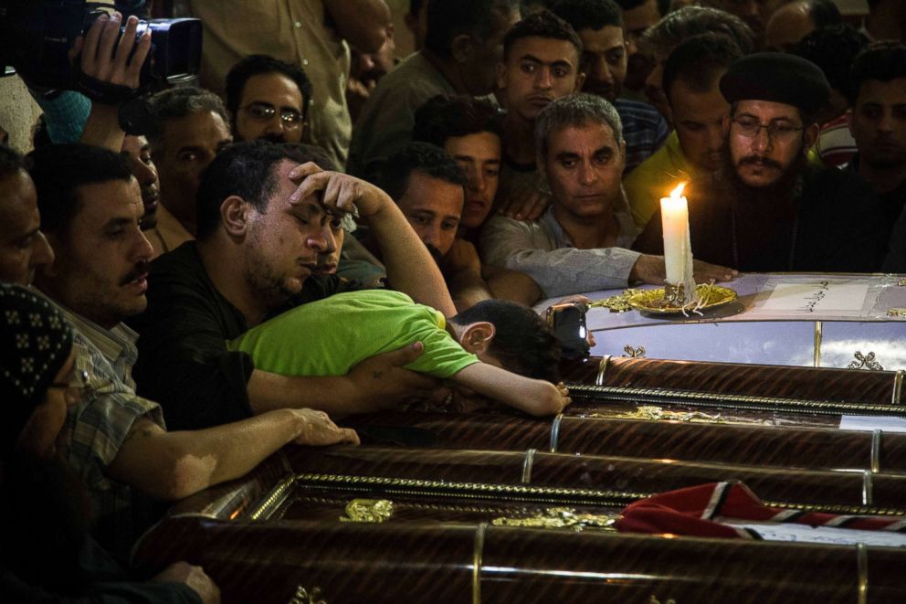 PHOTO: A young boy grieves next to the coffins of his parents who were killed during a bus attack, during their funeral service at Ava Samuel desert monastery in Minya, Egypt, May 26, 2017.