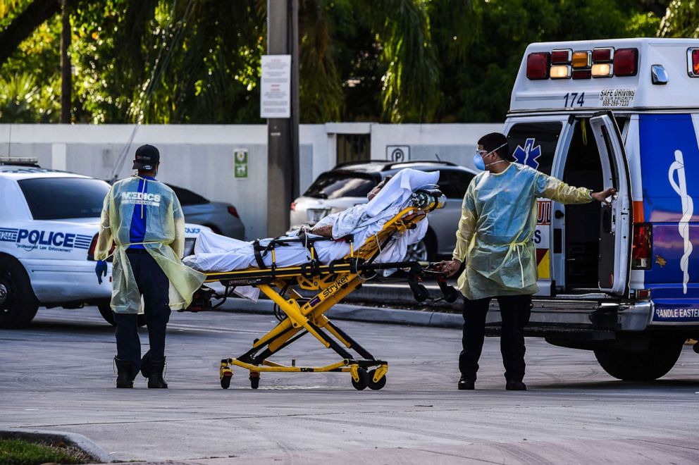 PHOTO: Medics transfer a patient on a stretcher from an ambulance outside of Emergency at Coral Gables Hospital where Coronavirus patients are treated in Coral Gables near Miami, July 30, 2020.