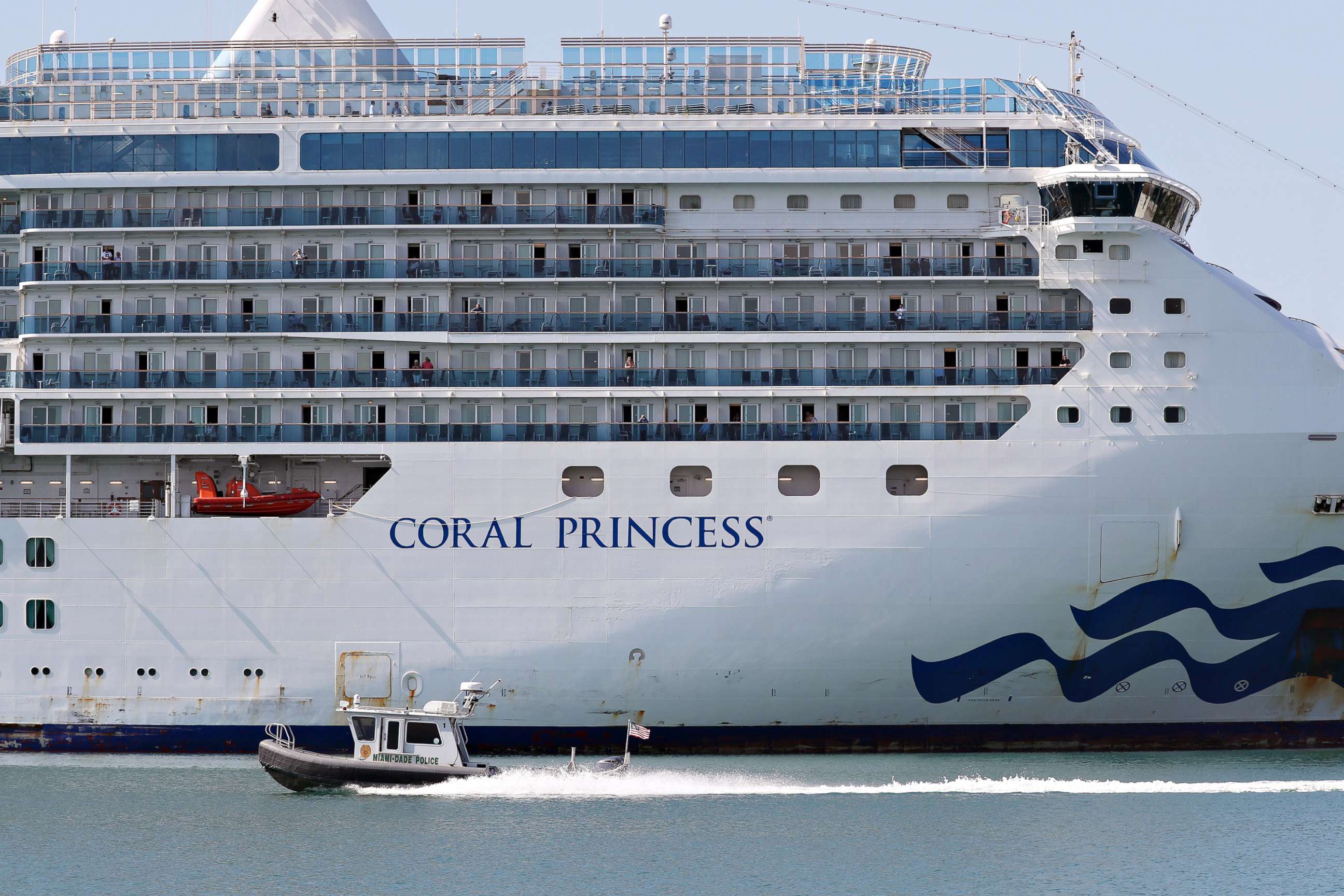 PHOTO: A Miami-Dade police boat passes the Coral Princess cruise ship after it docked at Port Miami, on April 04, 2020, in Miami.