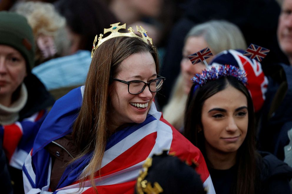 PHOTO: People wait to watch Britain's King Charles' procession to his coronation ceremony from Buckingham Palace to Westminster Abbey, at The Mall in London, May 6, 2023.
