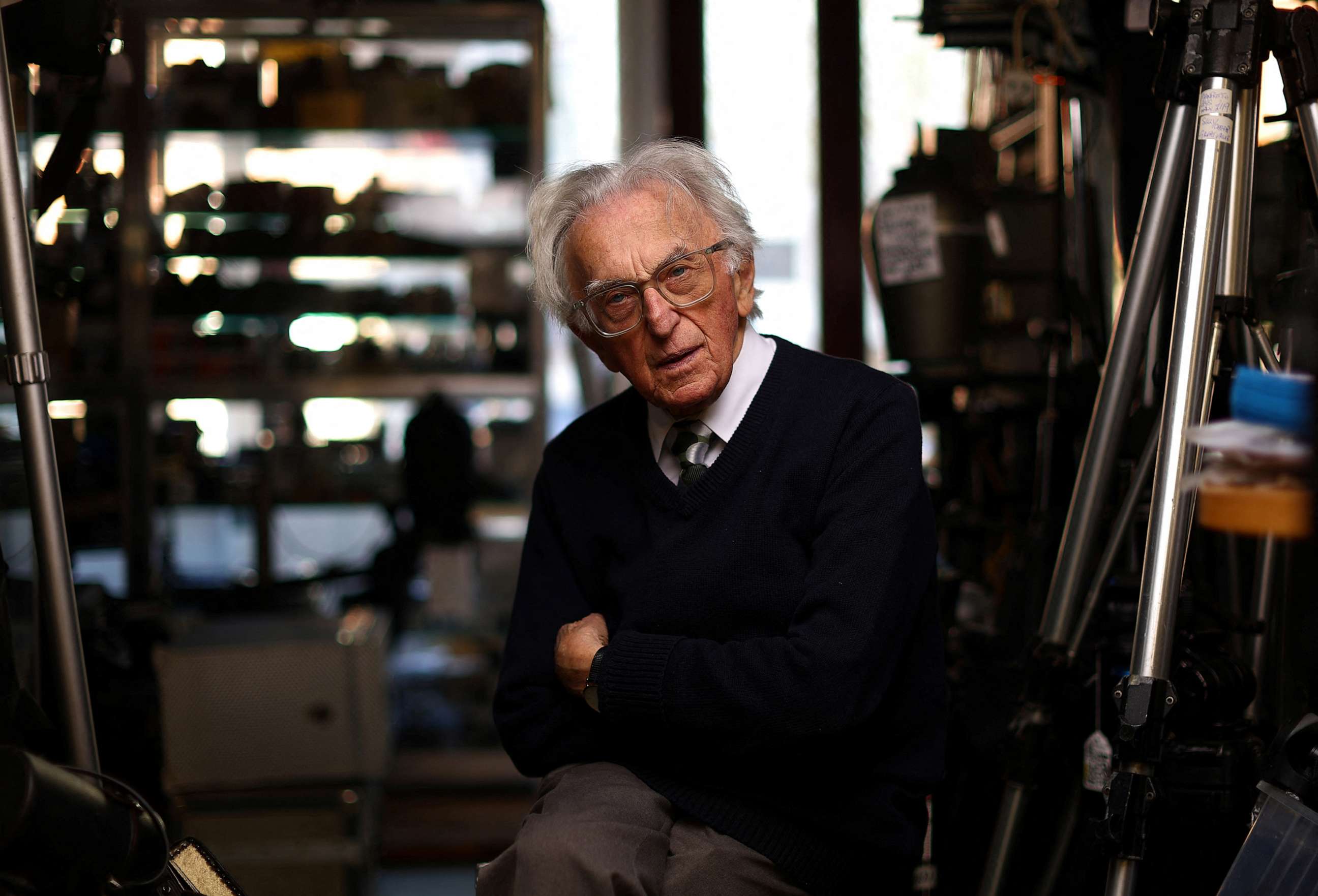 PHOTO: Alex Falk, 86, poses for a photograph in the Mr. Cad camera shop he owns in London, April 19, 2023.